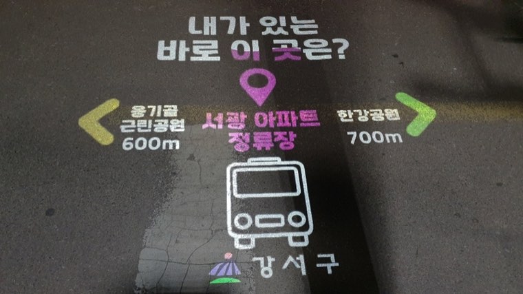 보도에 투사된 방향 안내 화살표와 거리 표시